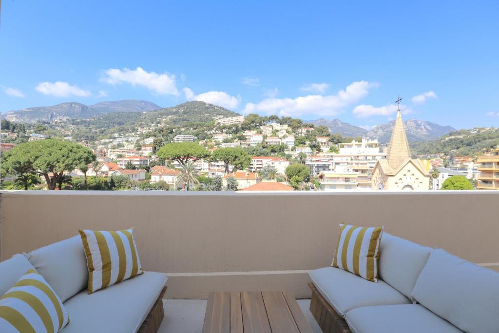 a living room with couches and a view of a city at Luxury 2bedrms with SeaView CityCenter&Parking #4 in Roquebrune-Cap-Martin