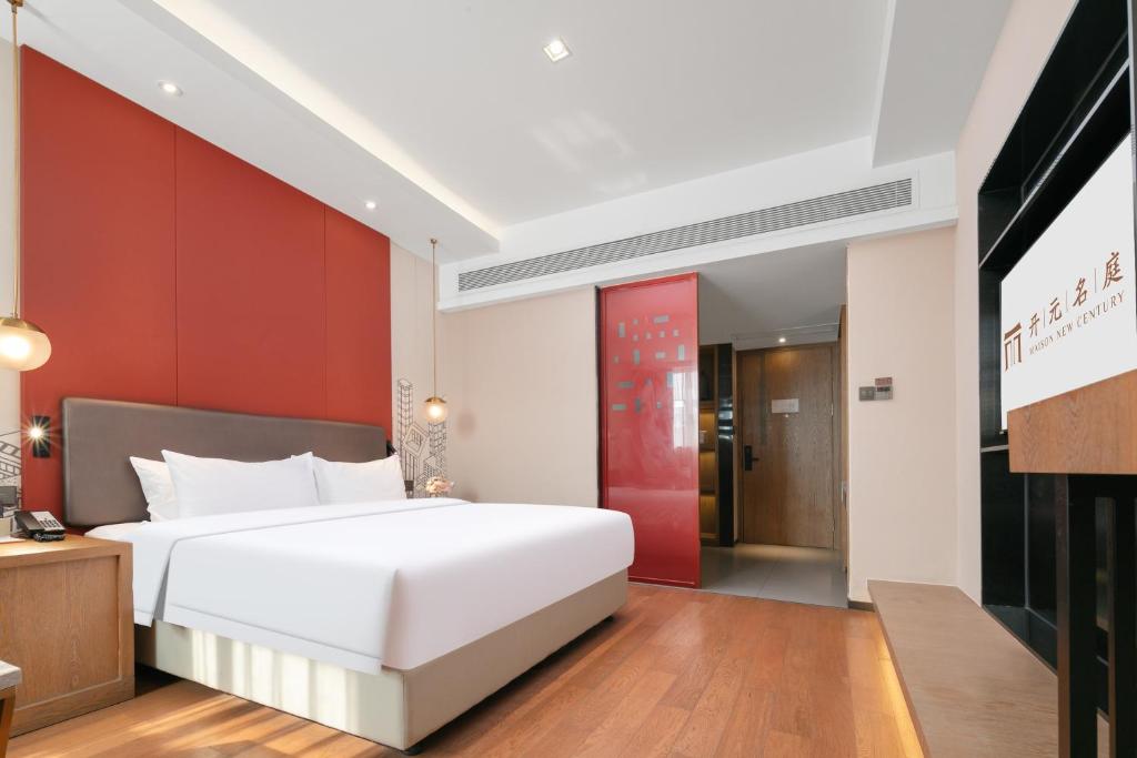 Postel nebo postele na pokoji v ubytování Mansion New Century Hotel Chengdu Wuhou
