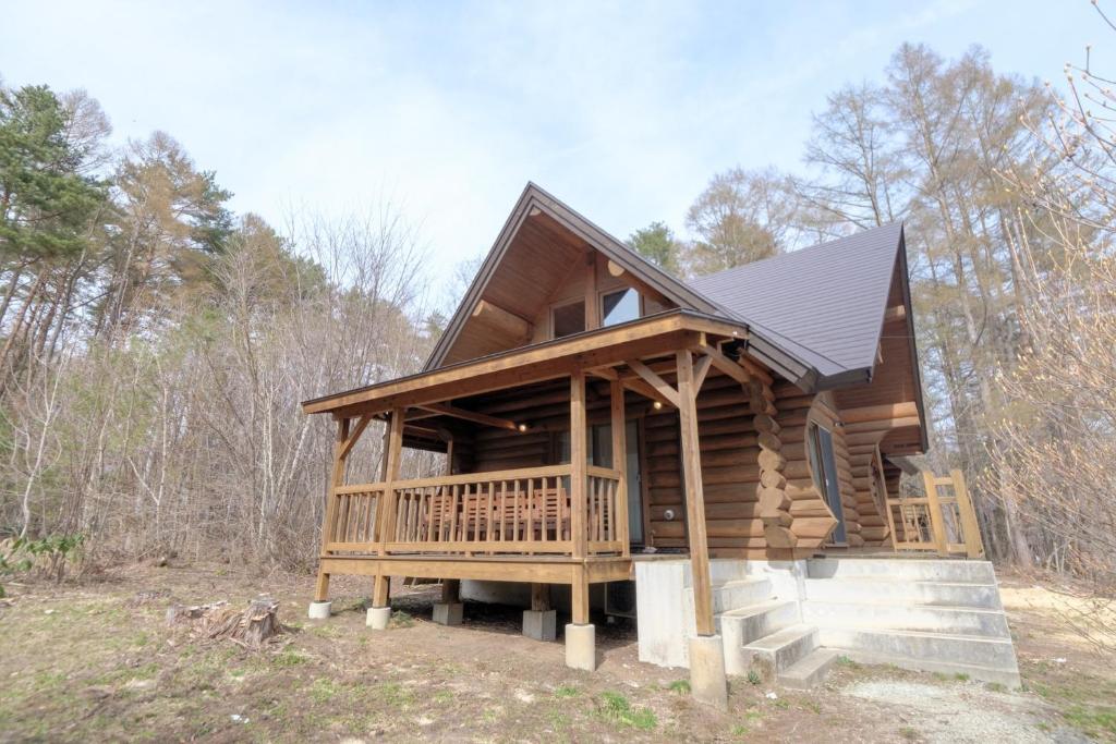 a cabin in the woods with a large deck at Shakunagedaira Rental Cottage - Vacation STAY 18468v in Numajiri