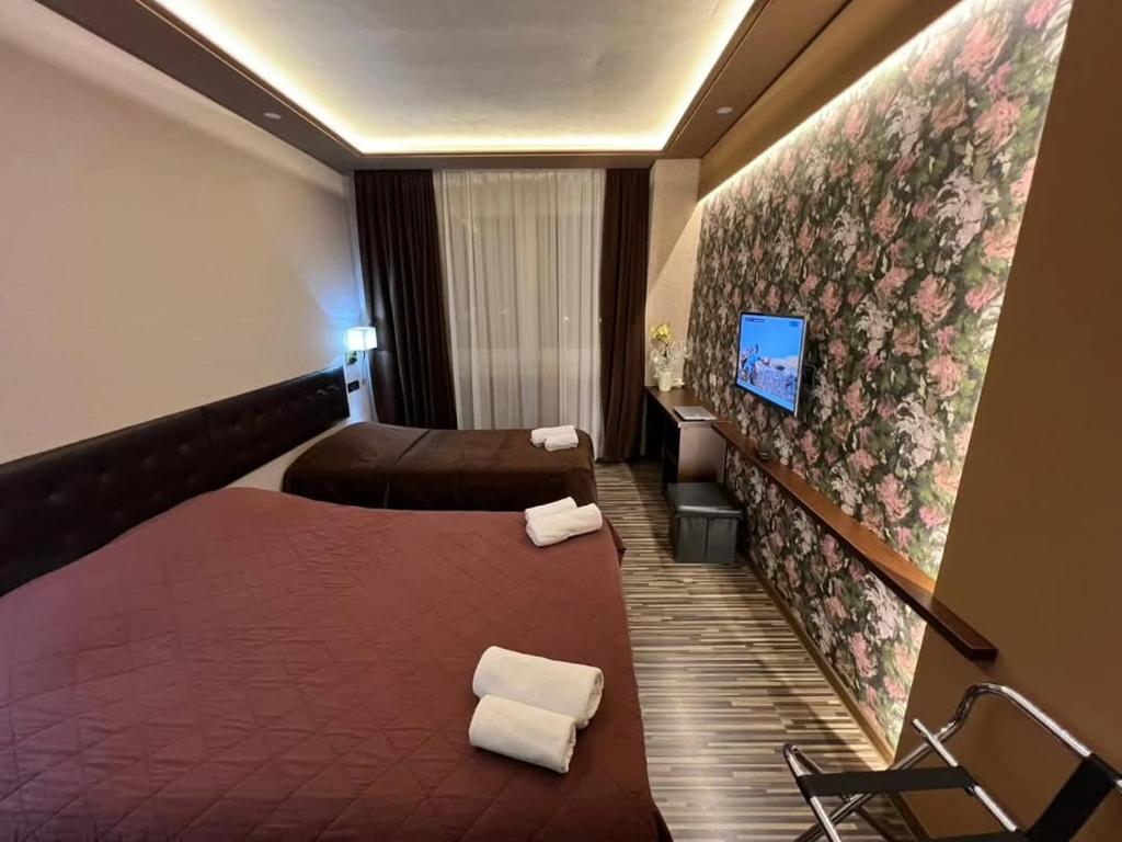 Postel nebo postele na pokoji v ubytování Hotel Petrus