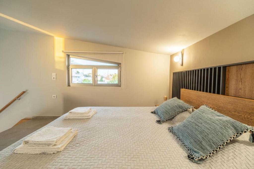 a bedroom with a large bed with two pillows on it at Jarko Luxury Houses in Argoulidhés