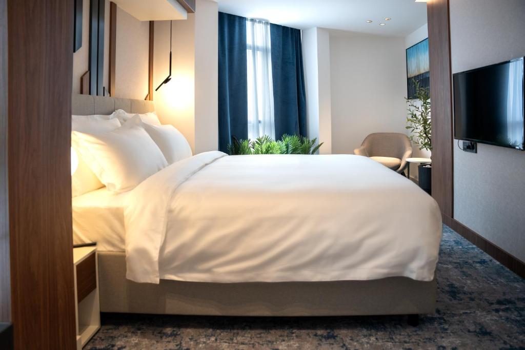 Postel nebo postele na pokoji v ubytování Hotel Rubin DHS