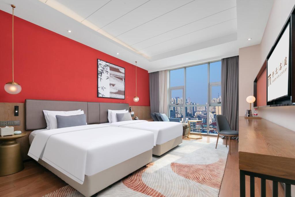 Postel nebo postele na pokoji v ubytování Mansion New Century Hotel Chengdu Wuhou