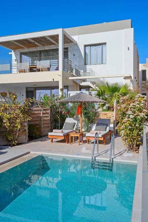 The swimming pool at or close to Ammokrinos Luxury Homes, 150m From Sea