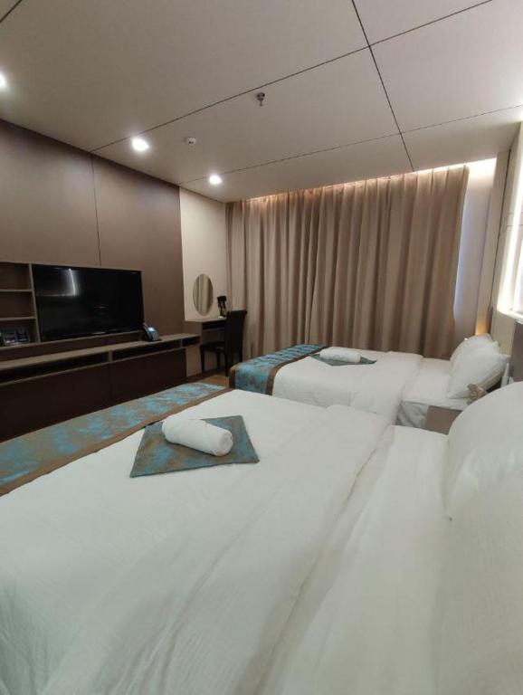 Postel nebo postele na pokoji v ubytování Skyport Hotel