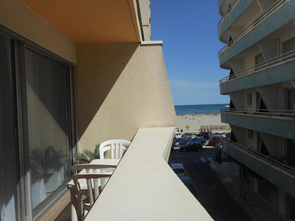 d'un balcon avec des chaises et une vue sur la plage. dans l'établissement Centre Rive Gauche, à Palavas-les-Flots
