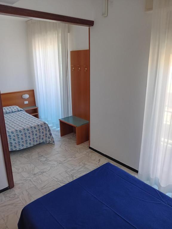 Postel nebo postele na pokoji v ubytování Hotel Valentino