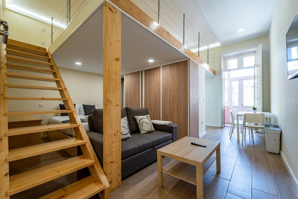 ein Wohnzimmer mit einer Couch und einer Treppe in der Unterkunft Close to Everything Your Oporto Terrace PRM 1T in Porto