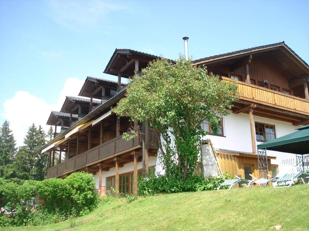 a large building with a tree in front of it at Ferienwohnung Rachel Mit Herrlichem Ausblick in Rinchnach