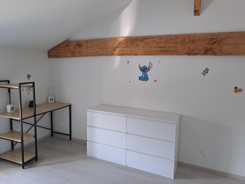 Cette chambre comprend une armoire blanche et un bureau. dans l'établissement Chambre chez l'habitant, à La Ronde