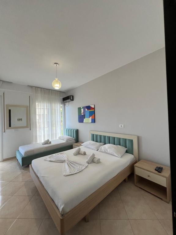 a bedroom with two beds with towels on them at The Blue Horizon in Vlorë