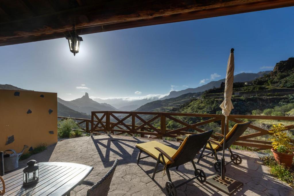 a patio with chairs and a table and a view at Casa Rural Cottage Bentayga in Tejeda