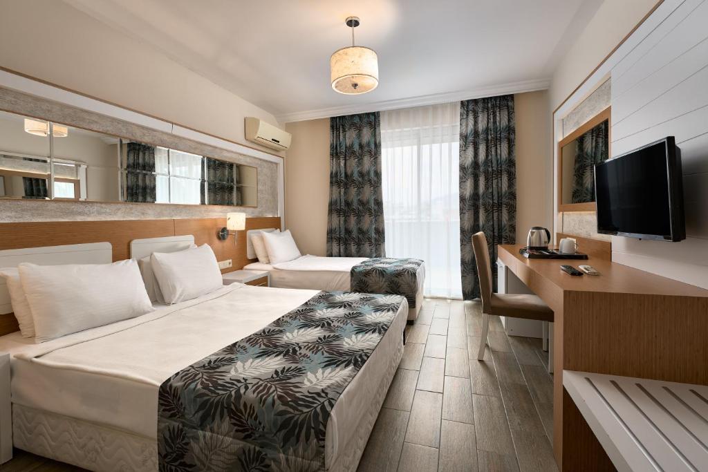 Postel nebo postele na pokoji v ubytování Kaila Beach Hotel - All Inclusive