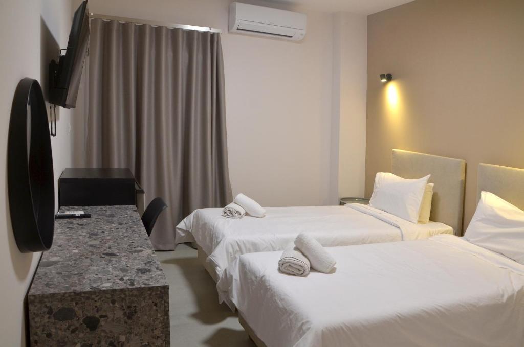 Postel nebo postele na pokoji v ubytování Centroom Suites