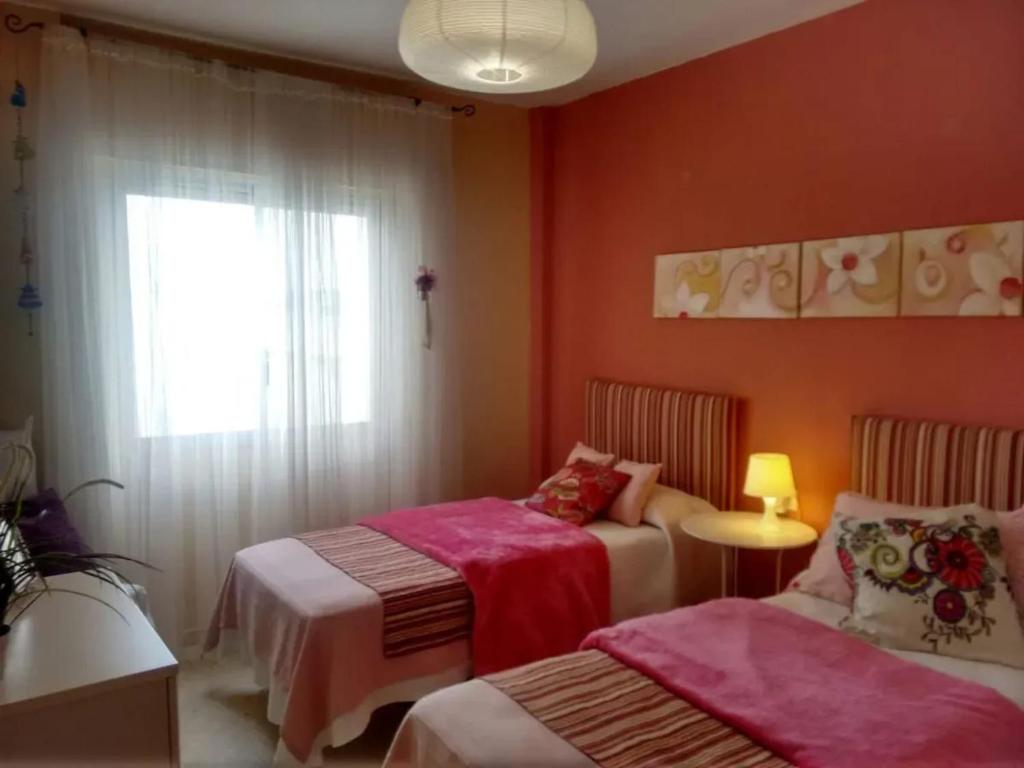 A bed or beds in a room at Charming apartment in El Puerto de Santa María with terrace
