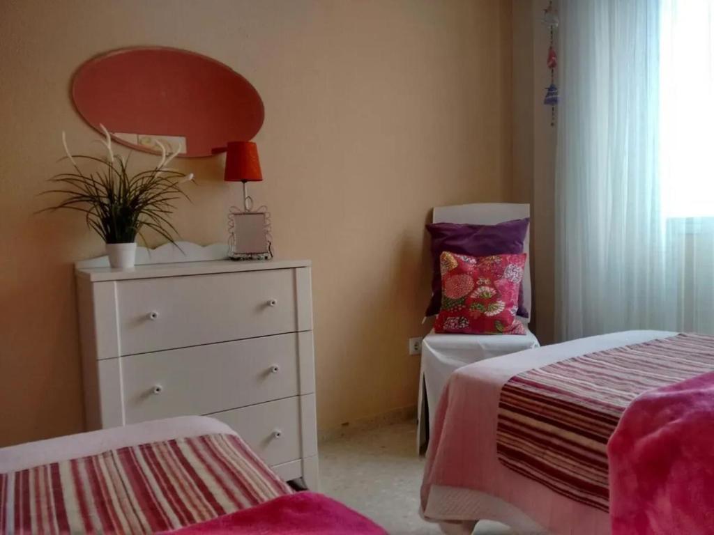 A bed or beds in a room at Charming apartment in El Puerto de Santa María with terrace