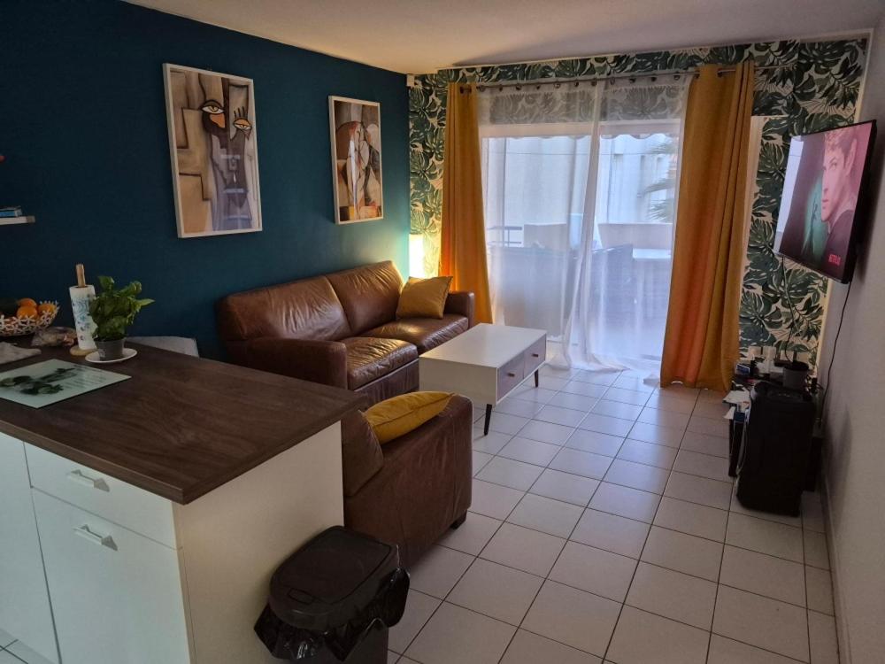 un salon avec un canapé et une table dans l'établissement Proche plage, à Saint-Raphaël