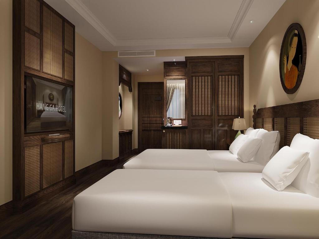 Postel nebo postele na pokoji v ubytování Lotusama Central Hanoi Hotel