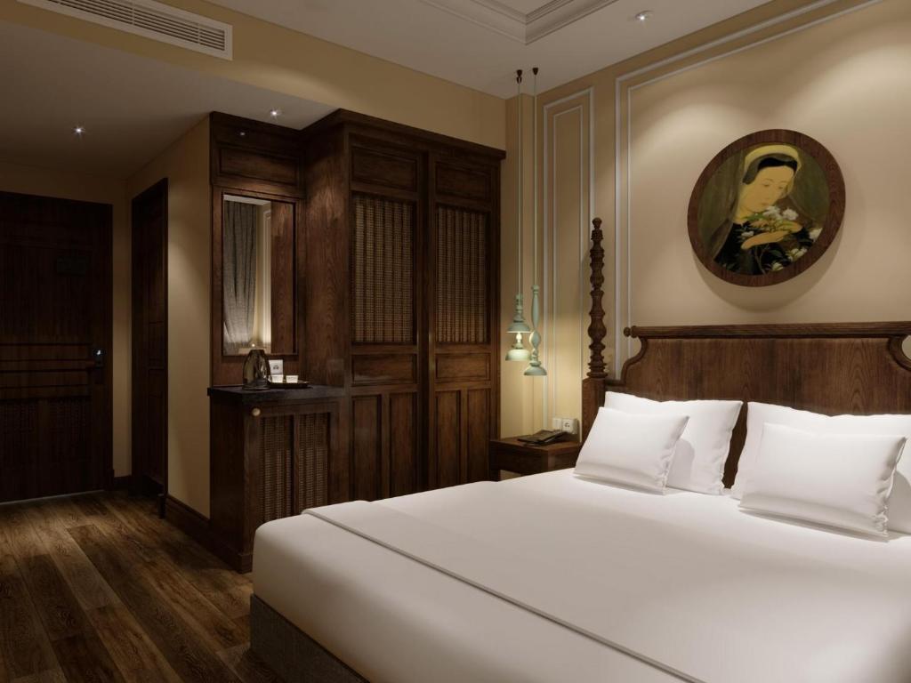 Postel nebo postele na pokoji v ubytování Lotusama Central Hanoi Hotel