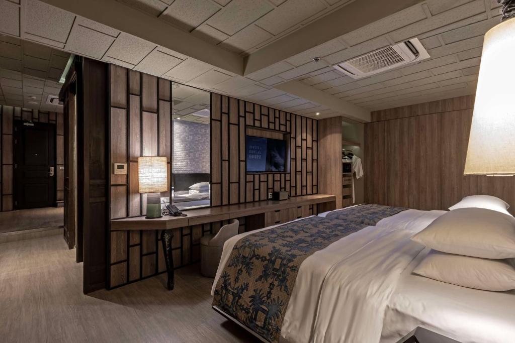 a hotel room with a bed and a desk at Siam@Siam, Design Hotel Bangkok in Bangkok