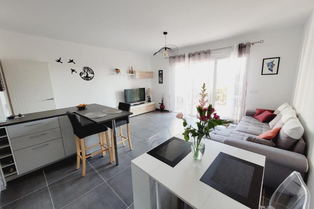 une cuisine et un salon avec un canapé et une table dans l'établissement Nice and peaceful 55m close to the city centre, à Aix-en-Provence