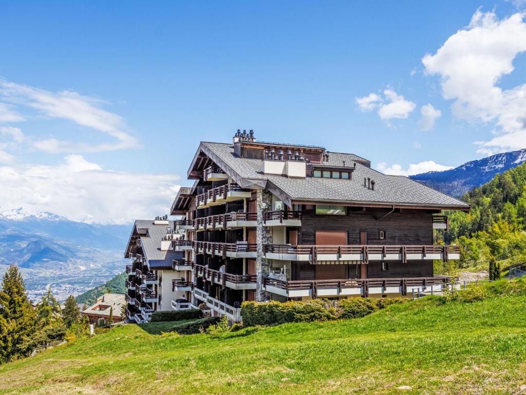 a large building on top of a hill at Apartment Hauts de Nendaz BI3 by Interhome in Nendaz