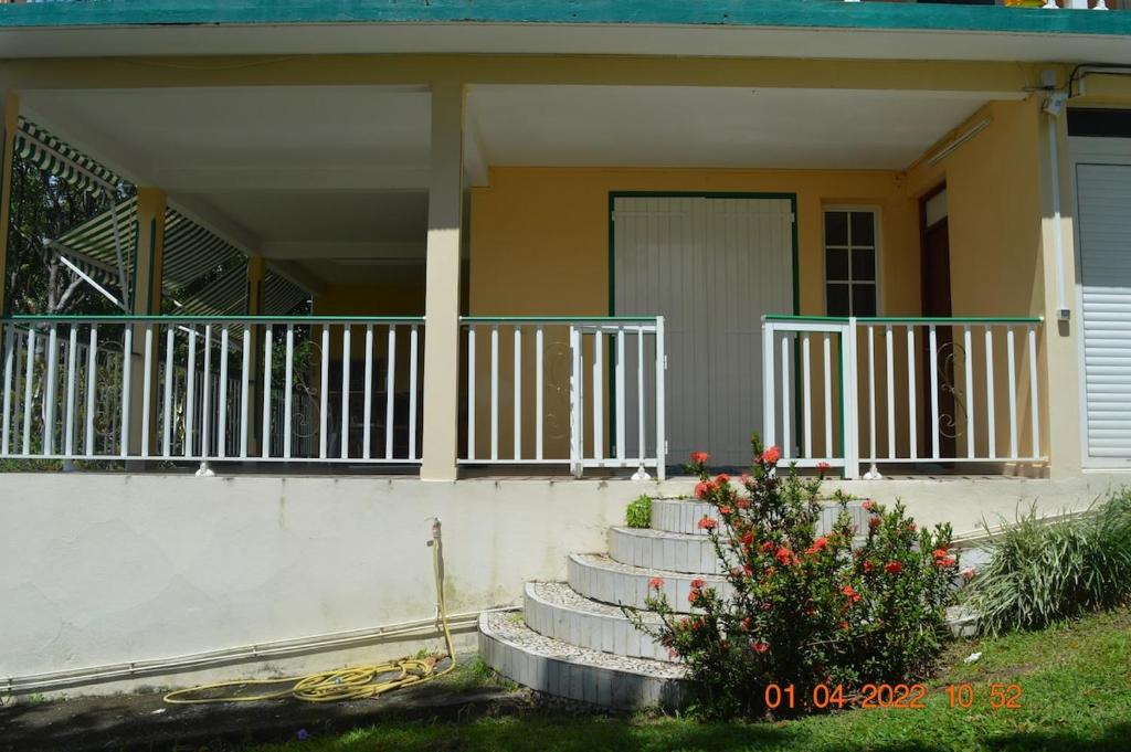 a house with stairs leading up to a porch at Villa nana in Pointe-Noire