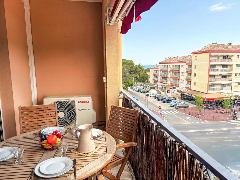 - une table sur un balcon avec vue sur la rue dans l'établissement Apartment Le Rabelais-1 by Interhome, à Saint-Aygulf
