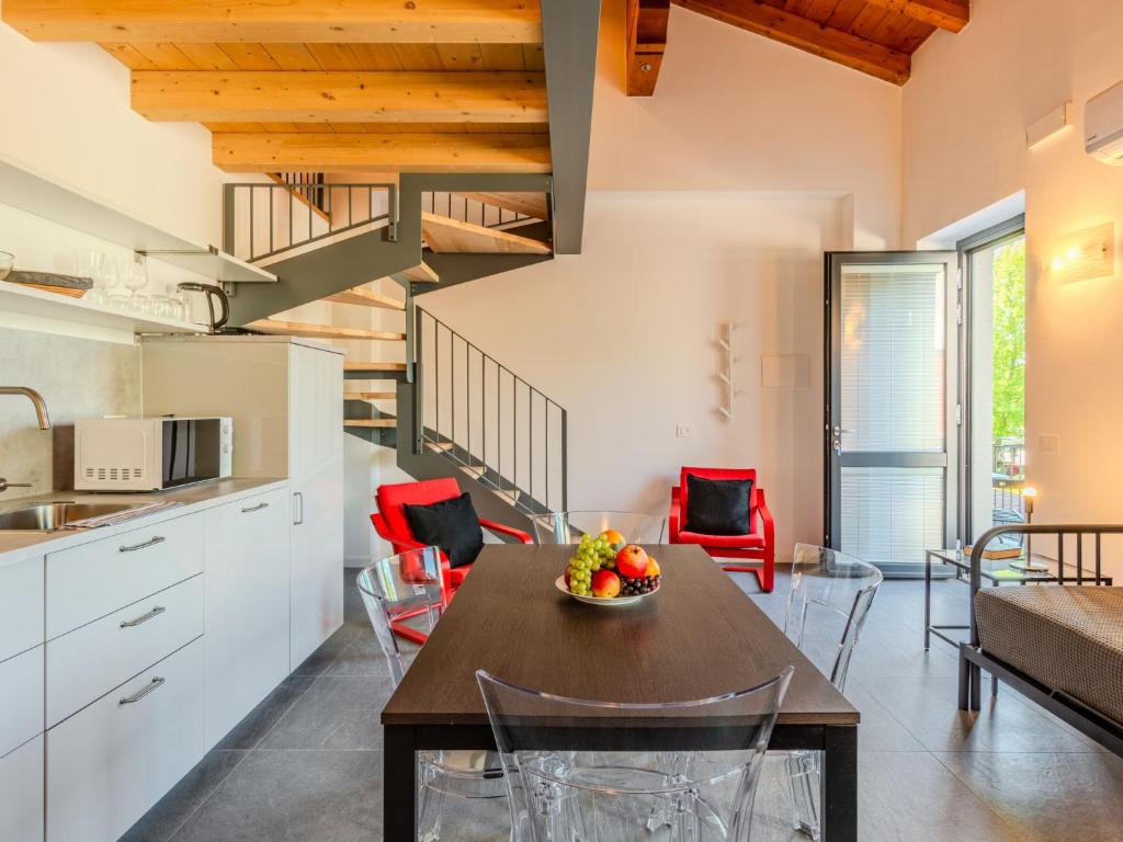 a kitchen and dining room with a table and chairs at Apartment Camping Turisport-1 by Interhome in Dervio