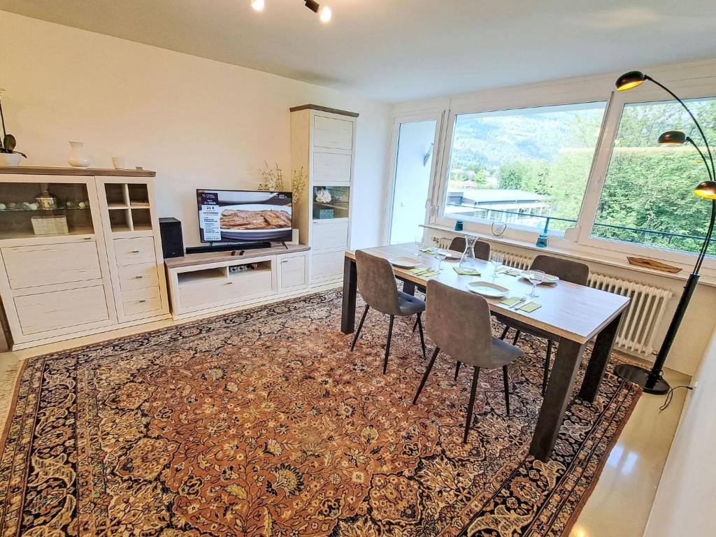 a dining room with a table and chairs and a window at Apartment Seezugang & Ski Ossiacher See by Interhome in Bodensdorf