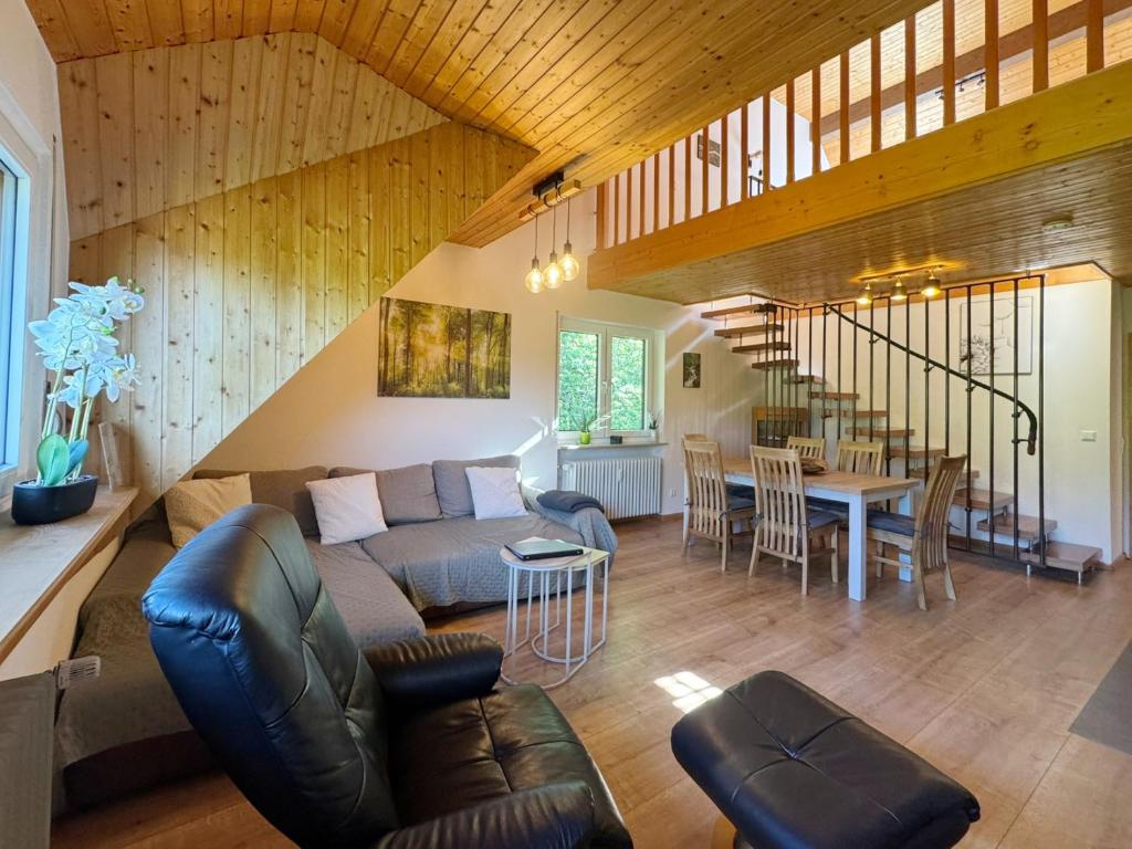a living room with a couch and a table at Black Forest Living, Todtnauberg, Feldberg in Rütte