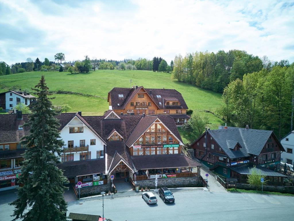 an aerial view of a large building with cars in a parking lot at Studio Rosie-Dolní náměstí by Interhome in Rokytnice nad Jizerou
