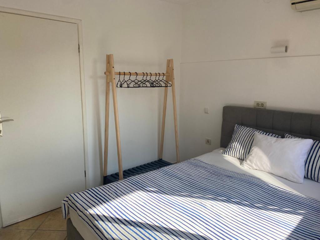 a small bedroom with a bed with blue and white sheets at Guest House Marta in Rovinj