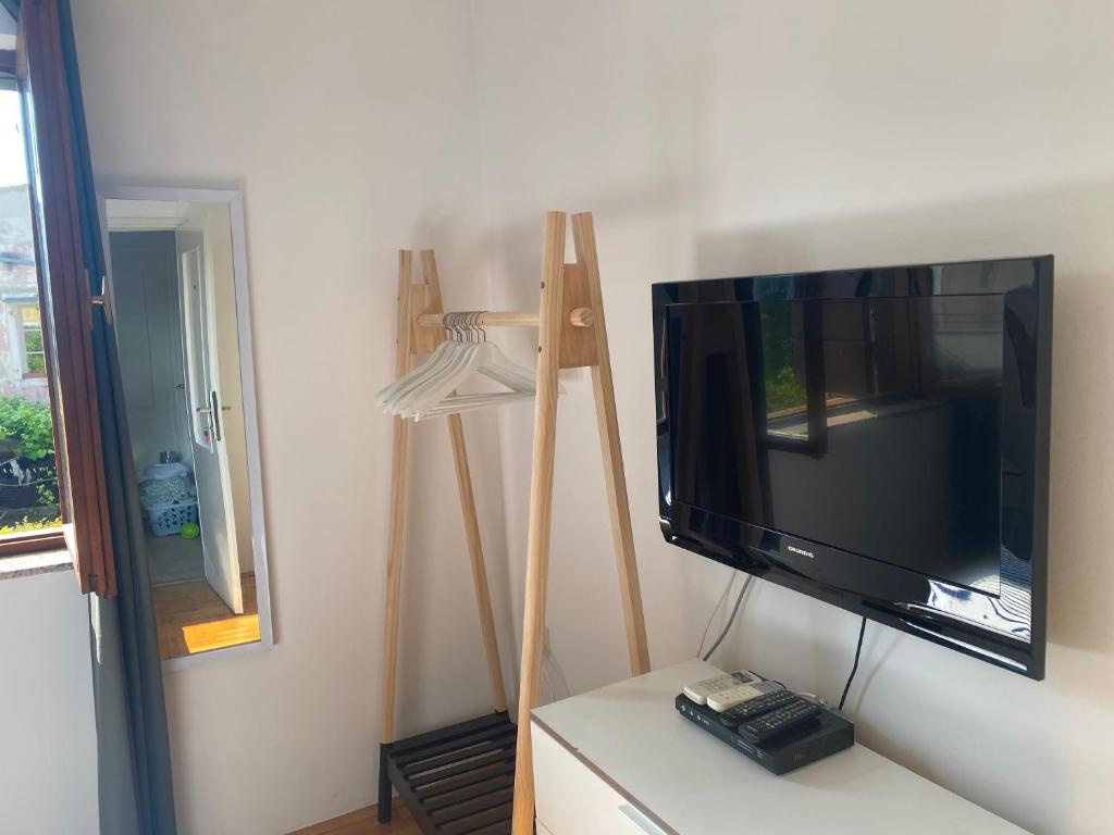 a flat screen tv sitting on a table next to a lamp at Guest House Marta in Rovinj