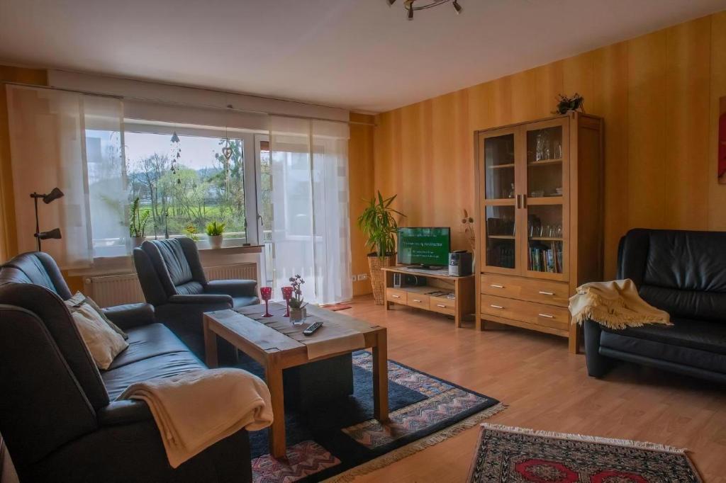 a living room with two couches and a table at Haus Herdlitschke in Polle