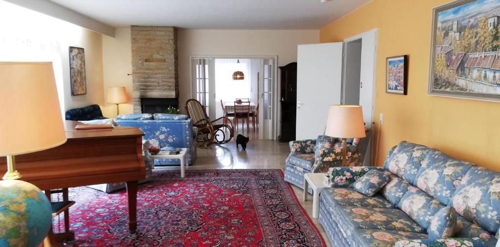 Una sala de estar con un sofá y un piano. en Appartement In Ruhbank Mit Garten Und Terrasse, en Pirmasens