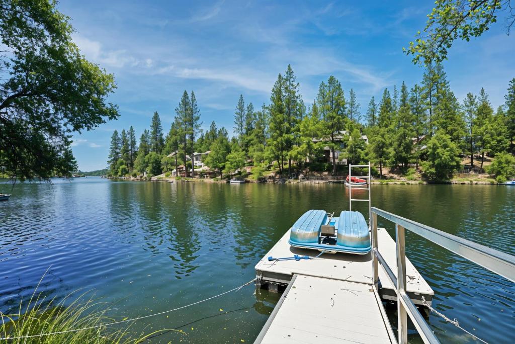 a small boat sitting at a dock on a lake at The Big Easy Lakefront Cabin in Groveland