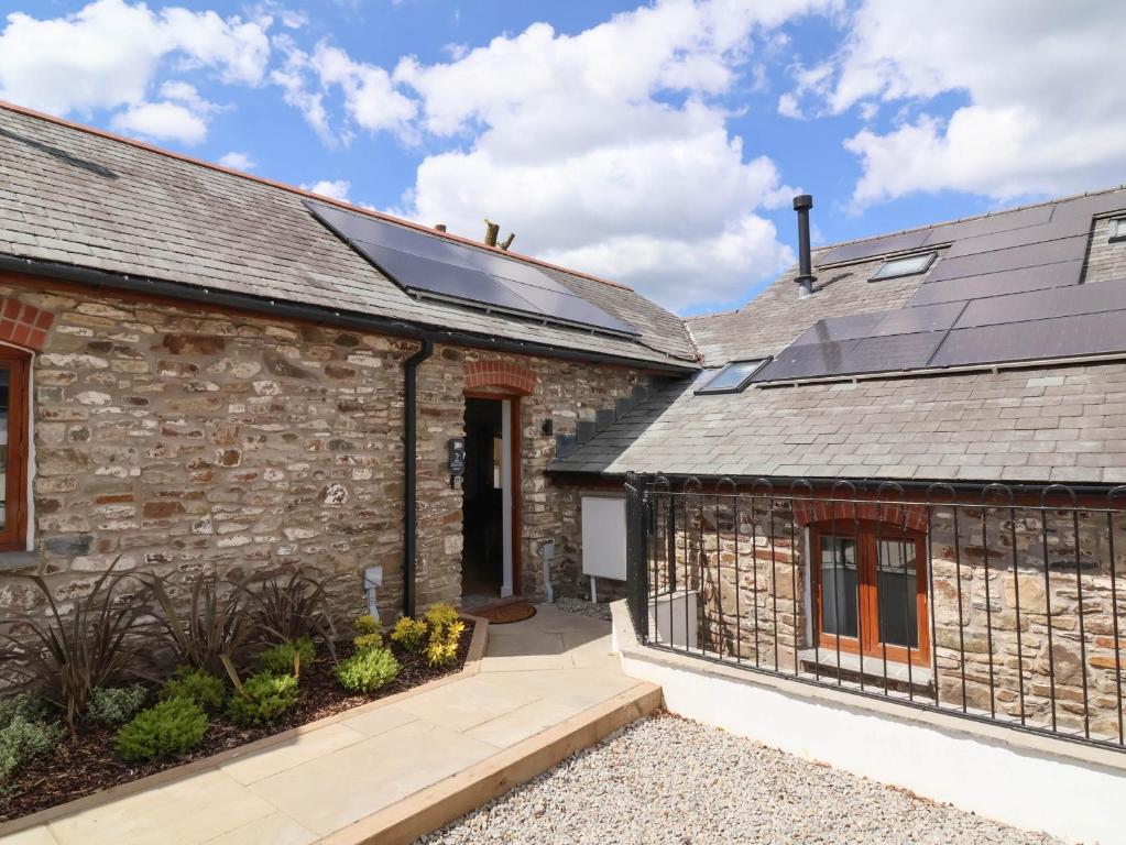 a house with solar panels on the side of it at Woodland Roost in Bideford