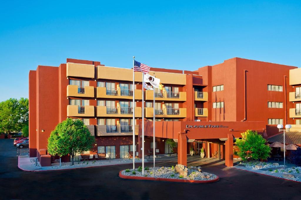 a building with an american flag in front of it at DoubleTree by Hilton Santa Fe in Santa Fe