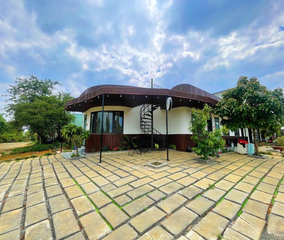 a house with a large patio in front of it at Homestay Nhà Của Gạo in Kon Tum