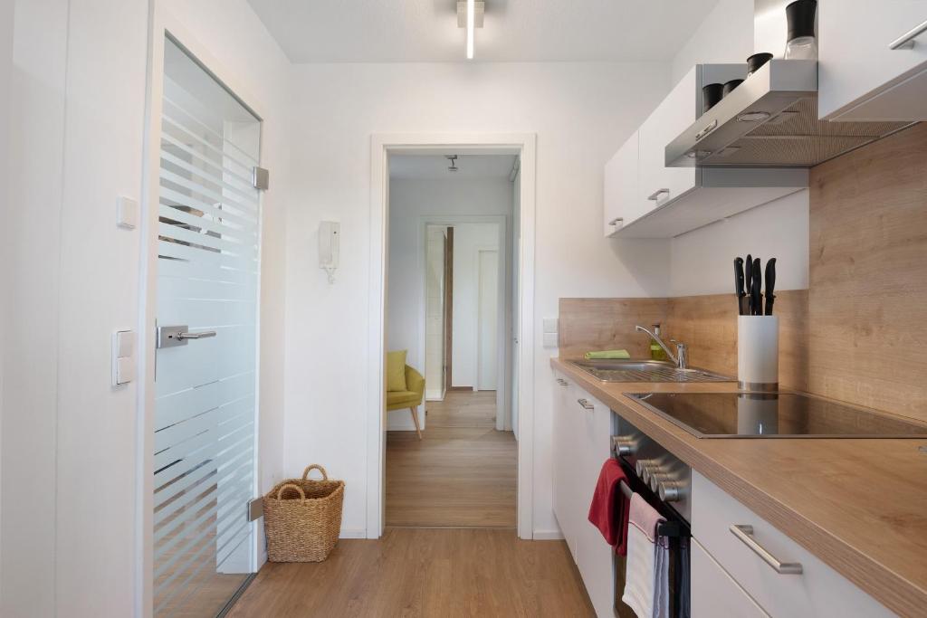 a kitchen with white cabinets and a counter top at Fewo Furtwangen in Furtwangen