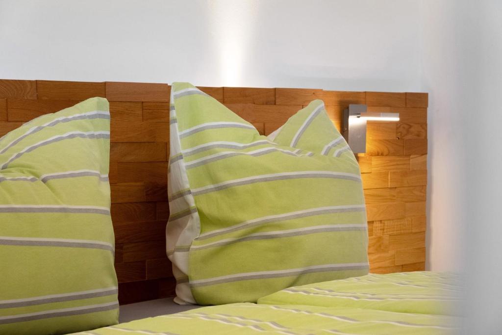 two pillows on a bed with a wooden headboard at Fewo Furtwangen in Furtwangen