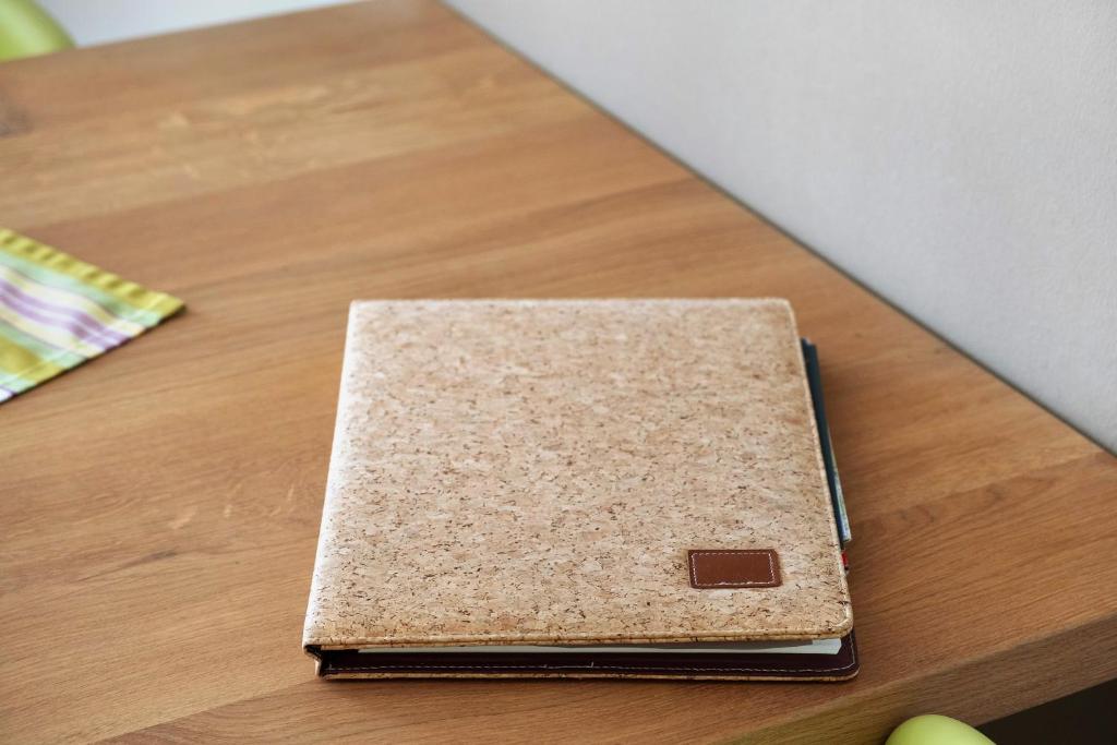 a brown notebook sitting on top of a wooden table at Fewo Furtwangen in Furtwangen