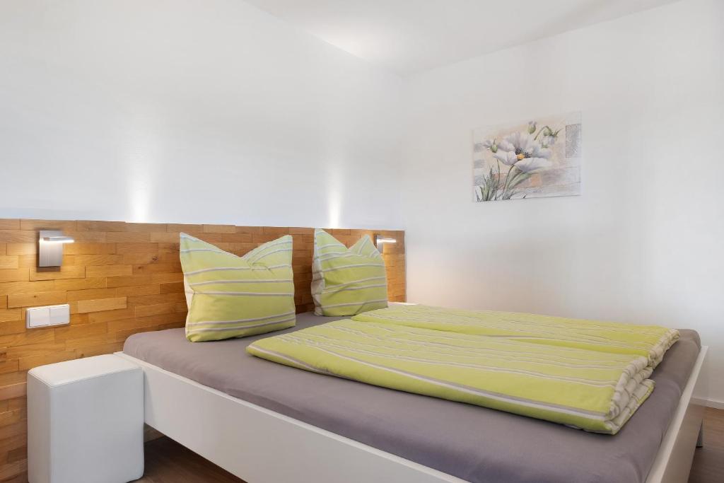 a bedroom with a bed with yellow pillows at Fewo Furtwangen in Furtwangen