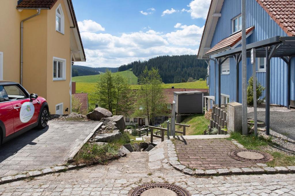 a red car parked in front of a building at Fewo Furtwangen in Furtwangen