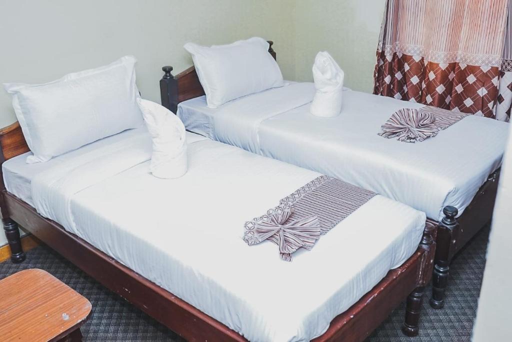 Postel nebo postele na pokoji v ubytování kapok city hotel