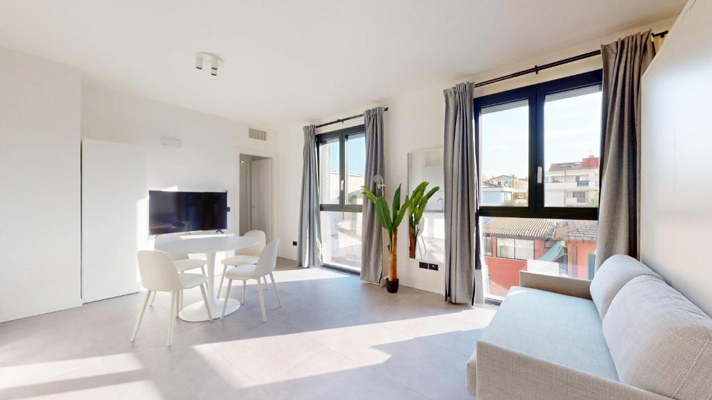a living room with a couch and a table at Baia Petrea - 2 Nuovissime Suite in Marina Centro in Rimini