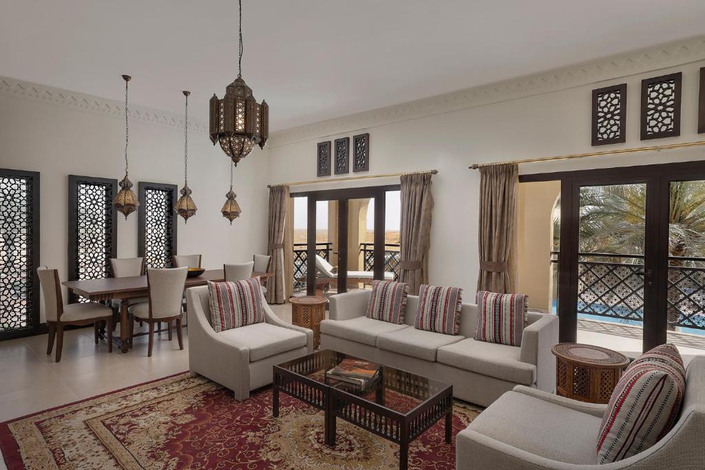 a living room with a couch and chairs and a table at Aldhafra Resort, Vignette Collection by IHG in Madīnat Zāyid