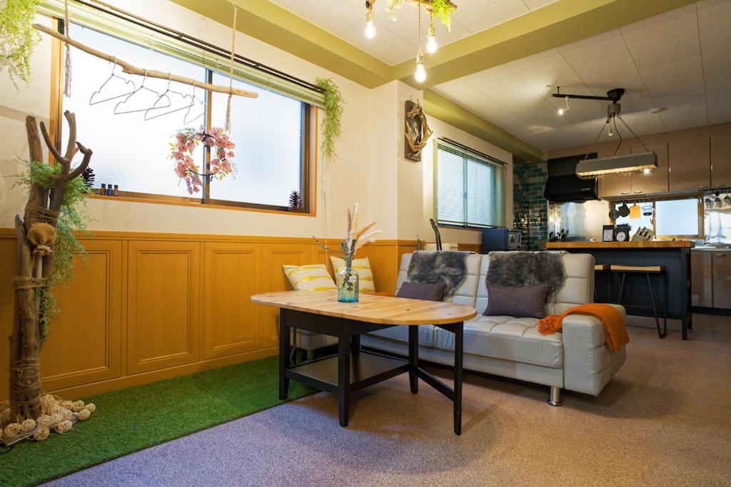 a living room with a table and a couch at Palette house Spacious 56 sqm Tokyo Apartment near Station in Tokyo