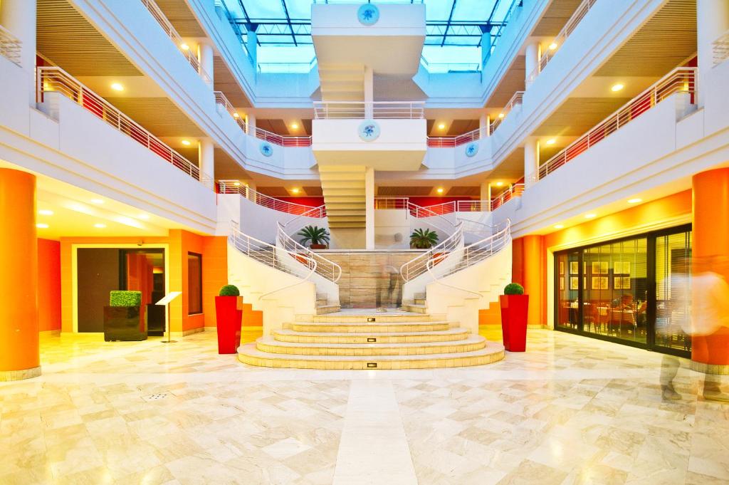 a lobby with a staircase in a building at Caesar's Hotel in Cagliari